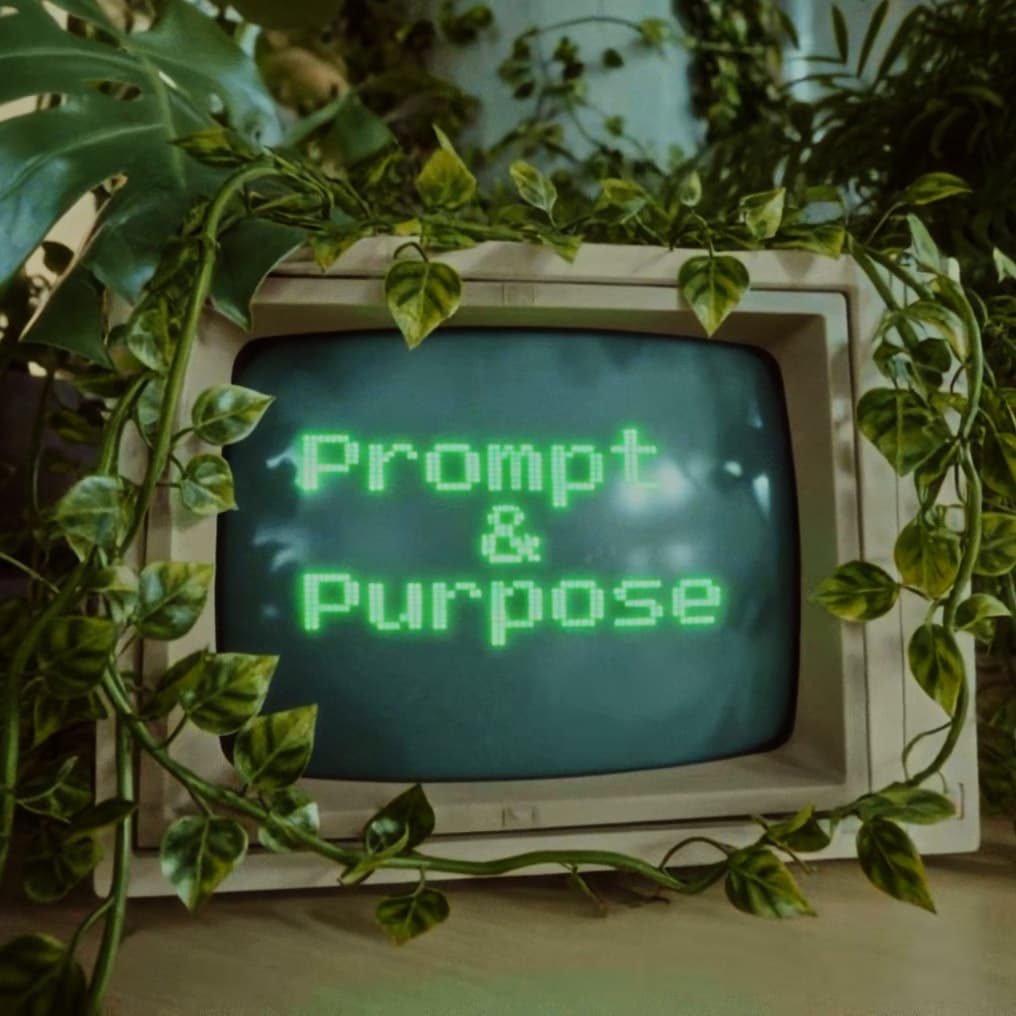 Vintage monitor displaying Prompt & Purpose, surrounded by plants